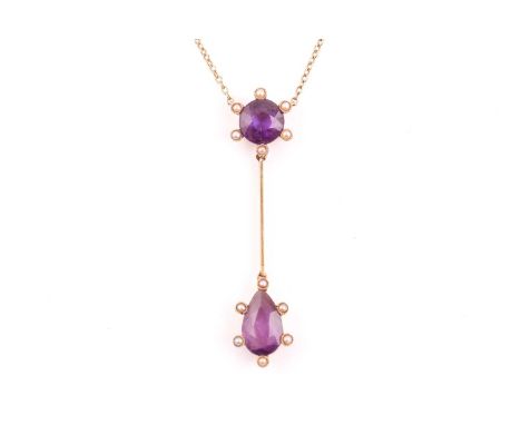 An early 20th century 15ct yellow gold and amethyst drop pendant necklace, set with a pear-cut and a round-cut amethyst, surr