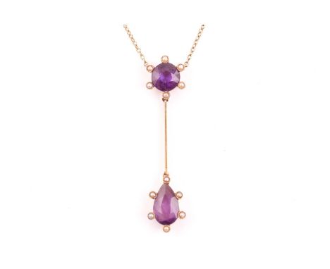 An early 20th century 15ct yellow gold and amethyst drop pendant necklace, set with a pear-cut and a round-cut amethyst, surr