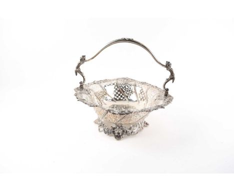 A Mappin and Webb silver basket, the swing handle cast with Chinese monopodia, the pierced rockwork and scroll cast border al