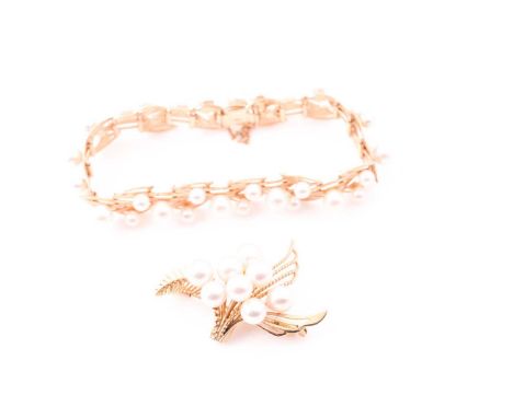 A yellow metal and pearl bracelet, the stylised openwork segments mounted with cultured pearls, fastened with a safety chain,