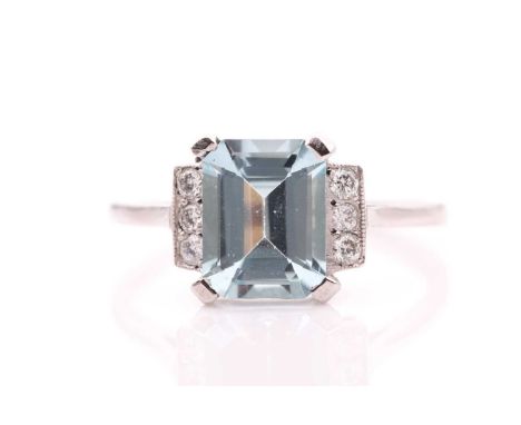 A platinum, diamond, and aquamarine ring, the emerald-cut aquamarine of approximately 2.0 carats, the shoulders each set with