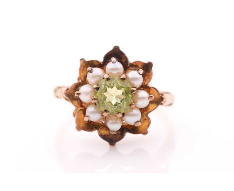 A 9ct yellow gold, peridot, and seed pearl floral cluster ring, ring head 16 mm diameter, size O 1/2.Condition report: 4 gram