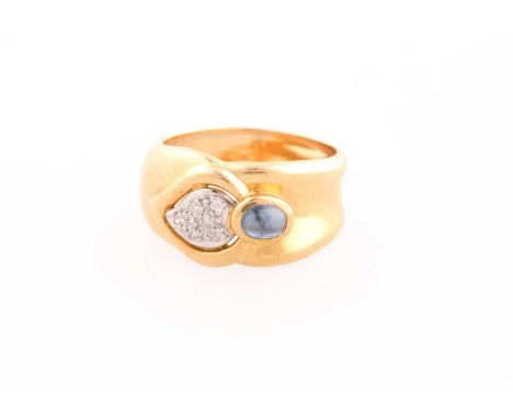 An 18ct yellow gold, diamond, and sapphire ring, set with a cabochon sapphire and a pave-set pear-shaped segment of diamonds,