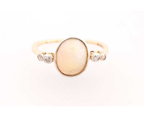 An 18ct yellow gold, opal, and diamond ring, set with a cabochon opal measuring approximately 11 x 9 x 6.4 mm, bezel-set, the