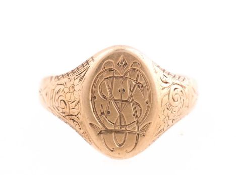 A 9ct gold signet ring, monogram engraved to the oval plaque; with foliate engraved shoulders.Birmingham 1928, size S 1/2, 8.