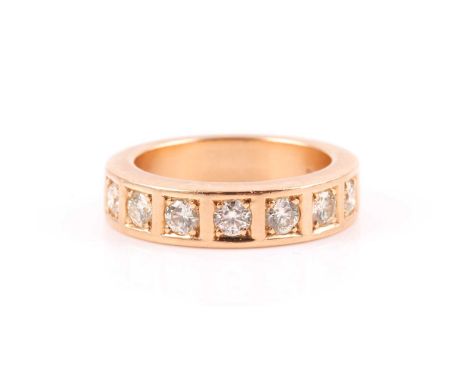 An 18ct yellow gold and diamond band ring, the heavy band inset with seven round brilliant-cut diamonds of approximately 0.70