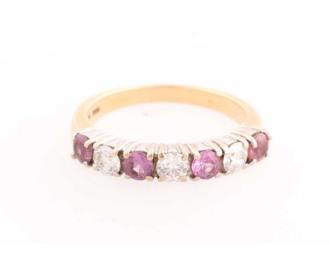 An 18ct yellow gold, diamond, and pink sapphire ring, set with three round-brilliant-cut diamonds of approximately 0.48 carat