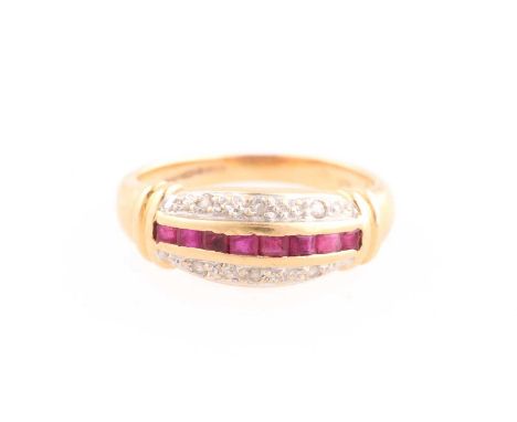 A ruby and diamond half hoop ring composed of a band of calibre cut rubies between curved bands of brilliant cut diamonds, to
