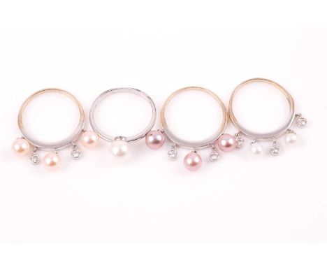 A set of 18ct white gold, diamond, and pearl rings, the three rings suspended with bezel-set diamond accents, and pale pink, 