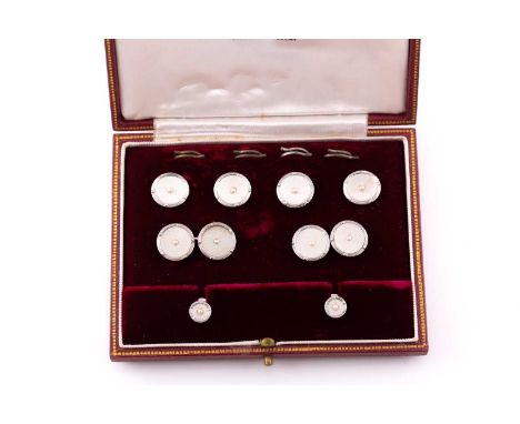 A 9ct white gold and waffle cut mother-of-pearl dress set. circular with central seed pearls; comprising a pair of cufflinks,