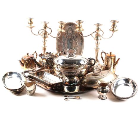 A mixed group of silver-plated items, to include vegetable tureens, a cocktail shaker, water jug, a three-sconce candlestick,