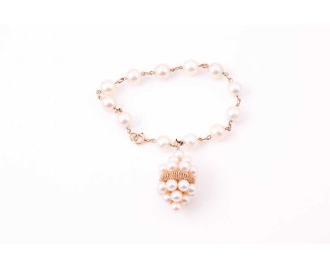 A yellow metal and pearl bracelet, set with cultured white pearls, the clasp marked 9K, suspended with a yellow metal and pea
