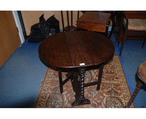 A 1940's Oak Occasional gateleg drop-leaf Table, having oval top, on two barley twist column legs with plank stretcher, two s