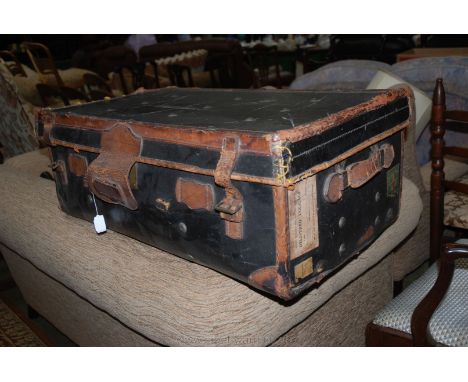 A Leather Trunk with White Star labels and others.