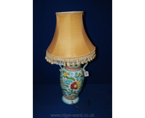 A Continental Hand Decorated Faience Table Lamp in Vase Style with Scrolled Handles & Tasseled Shade - 14" high.