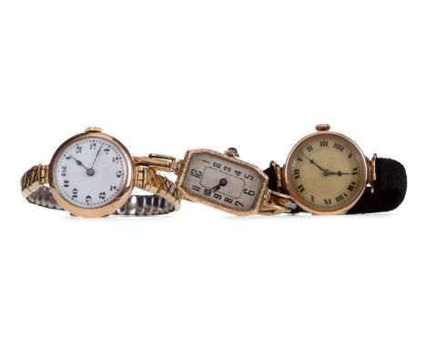 THREE LADY'S NINE CARAT GOLD CASED MANUAL WIND WRIST WATCHES,each unsigned, two on expanding straps and one on a fabric strap