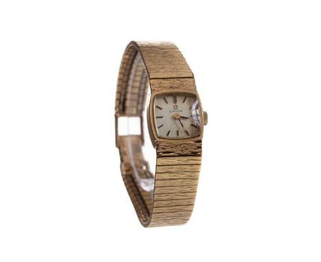 LADY'S OMEGA NINE CARAT GOLD MANUAL WIND WRIST WATCH,the cushion shaped dial with applied baton hour markers, 14mm case, on a