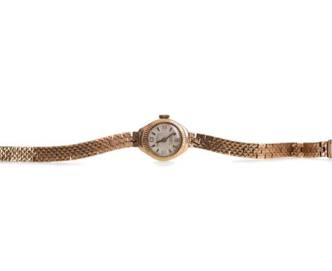 LADY'S ESSENZIAL NINE CARAT GOLD MANUAL WIND WRIST WATCH,the round silvered dial with applied baton and Arabic hour markers, 