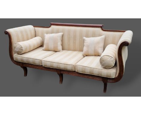 A William IV mahogany scroll end sofa with reeded arms and raised upon sabre front legs, 202cms long 