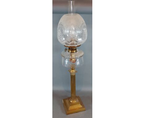 A brass Corinthian column oil lamp with etched glass shade and glass chimney, 71cms tall 