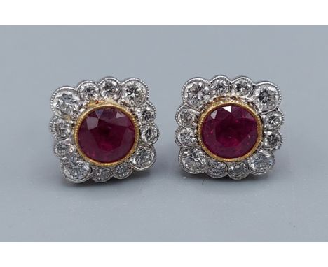 A pair of 18ct gold Ruby and Diamond set earstuds, each with a central Ruby surrounded by Diamonds, Ruby approx. 2.15ct and D