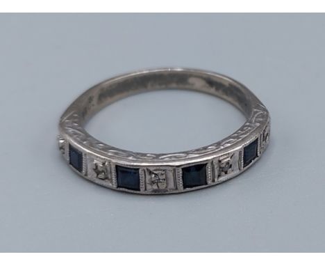 An 18ct white gold Sapphire and Diamond set half eternity ring, ring size M, 3.5gms 