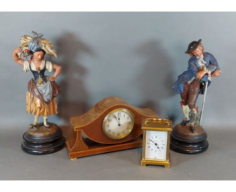 A pair of painted metal figures together with an Edwardian mantle clock and a brass cased carriage clock 