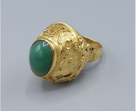 A 14ct gold ring set with a cabochon oval Jade stone, 12.9gms, ring size O 