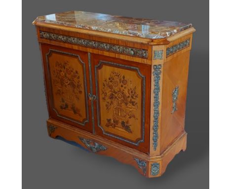 A French inlaid and gilt metal mounted commode, the variegated marble top above two inlaid doors raised upon bracket feet, 11