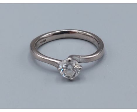 An 18ct gold solitaire diamond ring with crossover claw setting, approximately 0.35ct, ring size H, 2.6gms 