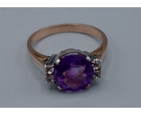 A yellow metal Amethyst and clear stone set ring, 2.7gms, ring size L 