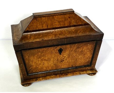 An interesting George IV pollard oak and rosewood sarcophagus tea caddy, circa 1825, with a stepped hinged top, panelled and 
