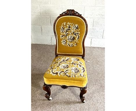 A pretty Victorian walnut framed nursing chair, circa 1870, with later floral tapestry back and seat, with squat cabriole leg