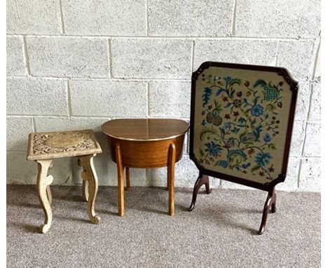 A firescreen, with embroidered panel, decorated with flora, 20th century; together with a small carved table and a work table