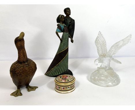 A decorative model of a Northern Pintail duck, with brass beak and feet, 22cm high; together with a glass eagle centrepiece, 