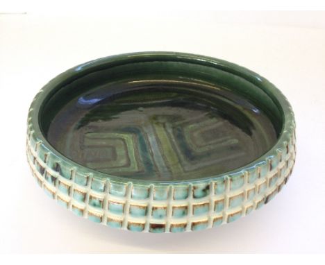 A Poole Pottery Studio period carved and glazed bowl, decorated in tones of green by Carolyn Bartlett (7").