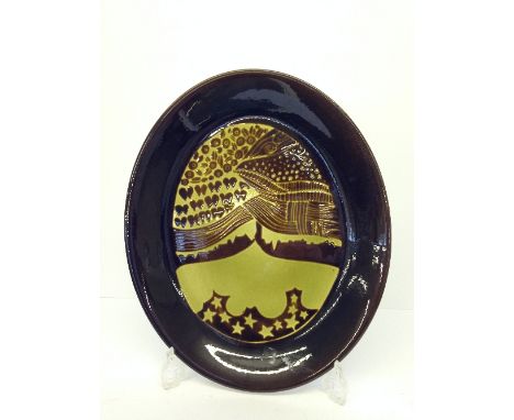 A Poole Pottery Aegean oval dish, decorated in a Fish design in tones of brown and green by Ros Sommerfelt.