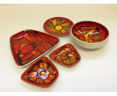 Four various Poole Pottery Delphis pin trays together with a small bowl.