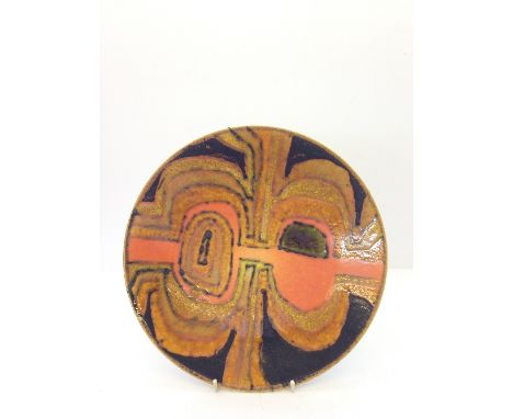 A Poole Studio dish, decorated in an abstract design in tones of green, orange and black, in the style of Tony Morris (10.5")