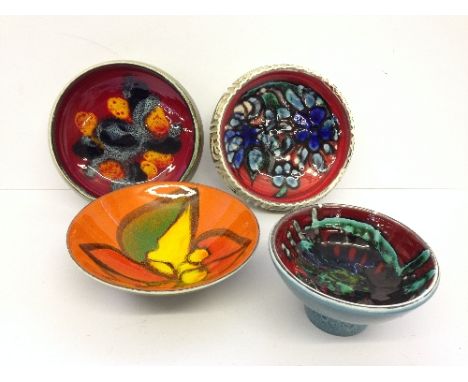 Four various Poole Pottery Delphis bowls, decorated in abstract designs by various artists.