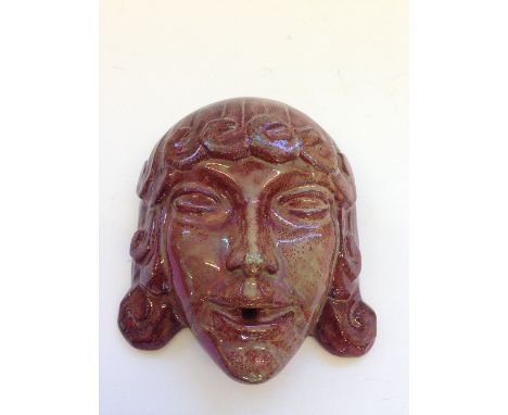 A Carter & Co. (Poole Pottery) red lustre stoneware fountain spout, modelled by James Radley Young in the form of a stylised 