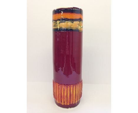 A Poole Pottery Delphis vase, shape 85, decorated in an abstract carved design in tones of red and orange.