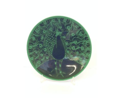 A large Poole Pottery dish, shape 45, decorated in a spray glazed design of a Peacock in tones of green (16").
