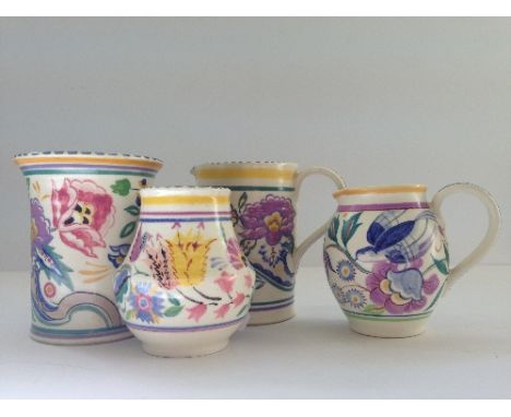 A small Poole Pottery vase, shape 115, decorated in the AP pattern by Marjory Cryer together with two jugs and a small vase.