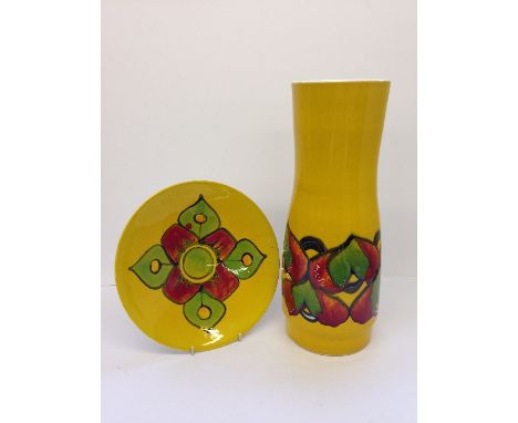 A Poole Pottery Delphis stick stand, shape 85, decorated in an abstract pattern in tones of green and red on yellow ground (c