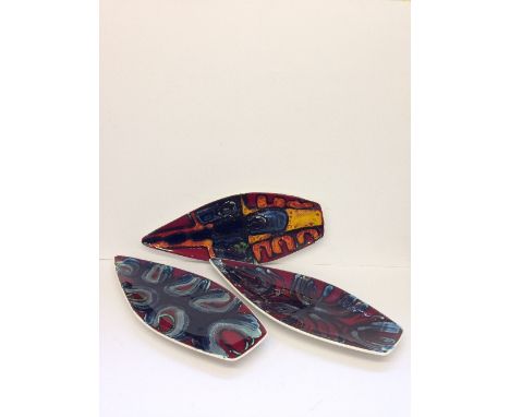 Three various Poole Pottery spear dishes, shape 82, decorated in abstract designs by various artists.
