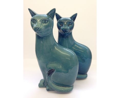 A pair of right facing blue glazed Poole Pottery Cats.