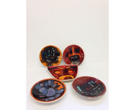 Four various Poole Pottery Delphis circular small dishes, shape 49, decorated in various abstract designs by different artist