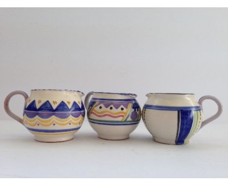 A small Poole Pottery jug decorated in the HI pattern by Marjory Batt together with another decorated in the QO pattern by Ma