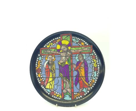 A Poole Pottery Crucifixion plate from the Cathedral Series, designed by Tony Morris in the stained glass window technique (o